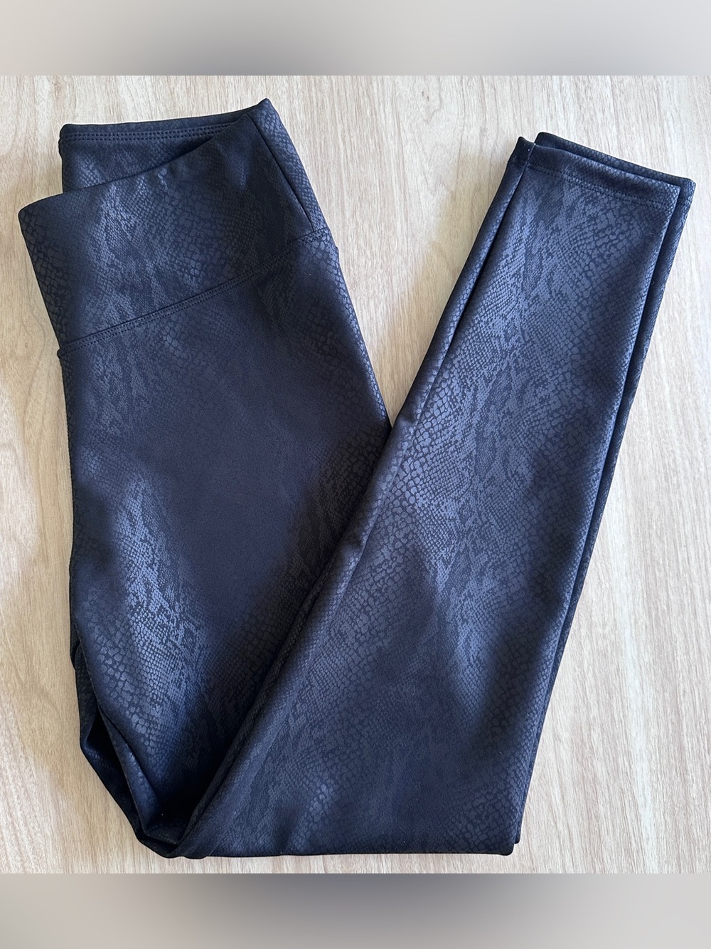 Express faux leather snakeskin print leggings in a sleek black-on-black finish.
